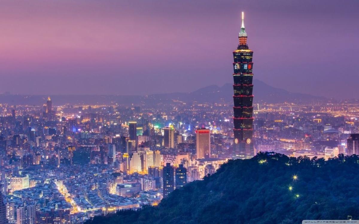 Tháp Taipei 101 rực rỡ với ánh đèn lấp lánh, nổi bật giữa cảnh quan thành phố Đài Bắc về đêm.